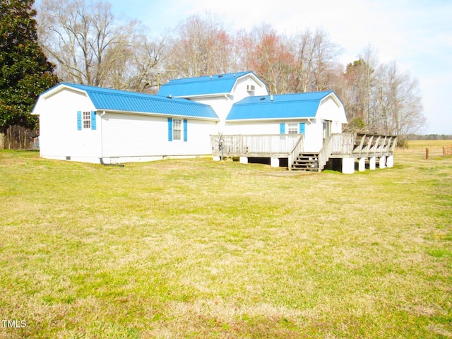 rear view of property with a wooden deck, a gambrel roof, metal roof, crawl space, and a yard