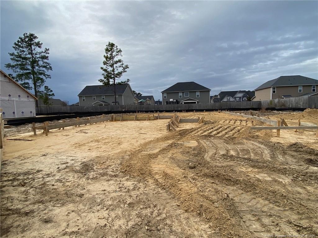 view of yard featuring a residential view and fence