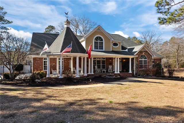 view of front of house with brick siding and a front lawn