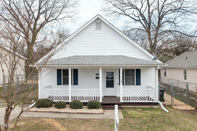 bungalow-style house featuring a shingled roof, covered porch, fence, and a gate