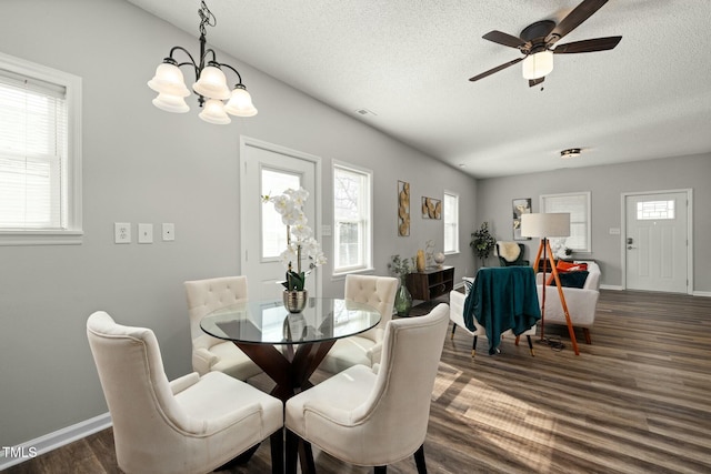 dining room with a textured ceiling, ceiling fan, dark wood-type flooring, and baseboards