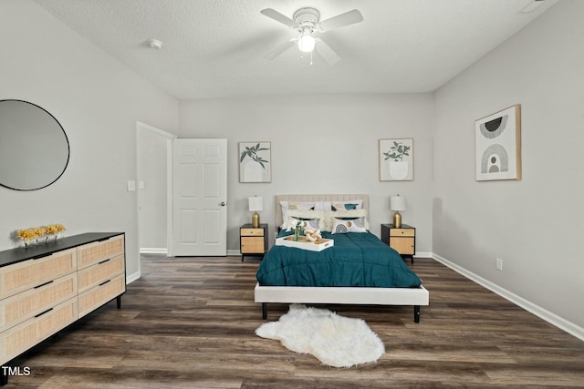 bedroom featuring a textured ceiling, ceiling fan, dark wood-style flooring, and baseboards