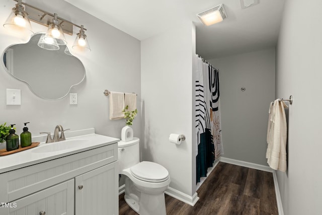 full bath with toilet, wood finished floors, vanity, visible vents, and baseboards