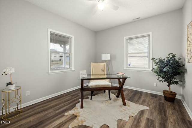 office featuring a ceiling fan, wood finished floors, visible vents, and baseboards