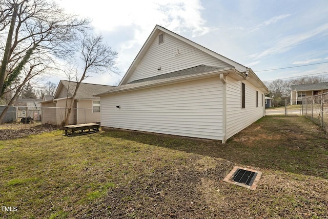 view of home's exterior with a yard and fence