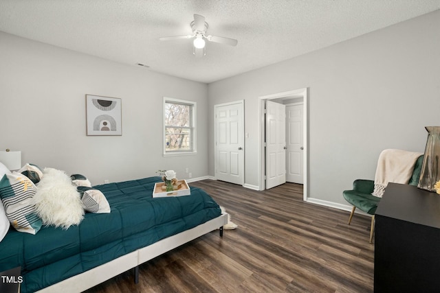 bedroom with visible vents, baseboards, ceiling fan, wood finished floors, and a textured ceiling