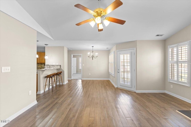 interior space featuring wood finished floors, visible vents, and baseboards