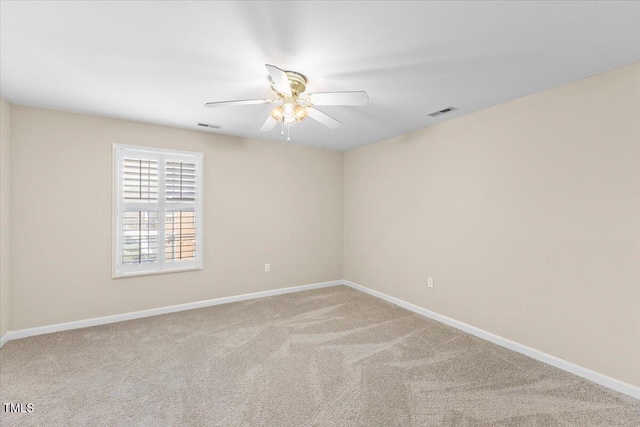 unfurnished room featuring baseboards, carpet flooring, visible vents, and a ceiling fan