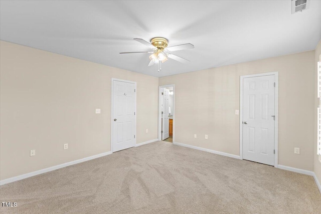 unfurnished room featuring ceiling fan, carpet, visible vents, and baseboards