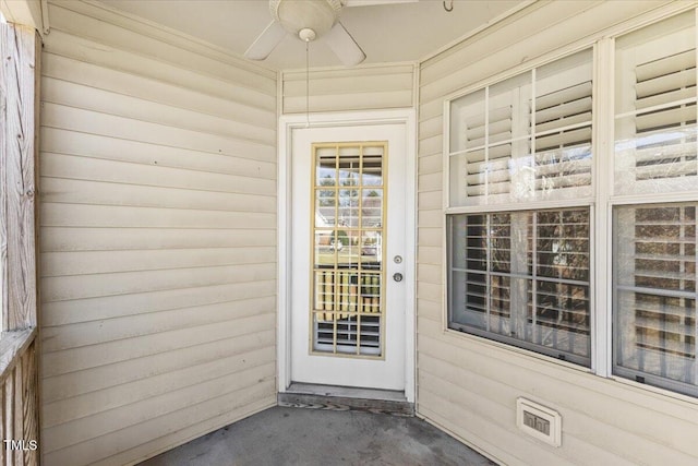 property entrance featuring a ceiling fan and visible vents