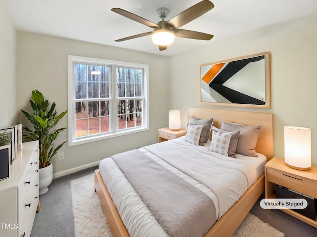 carpeted bedroom featuring a ceiling fan and baseboards