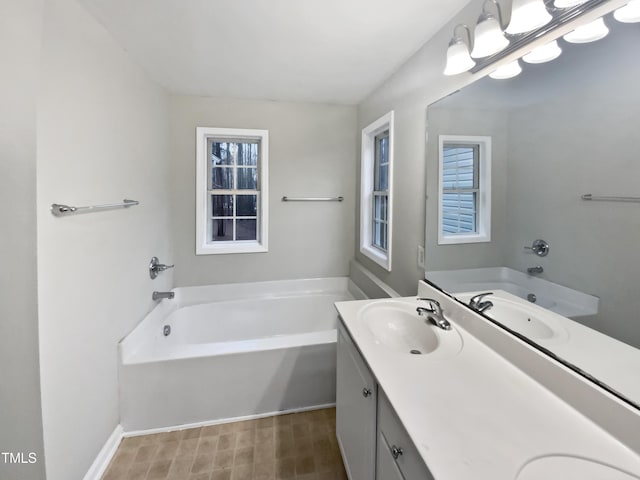 bathroom with a garden tub, a sink, and double vanity