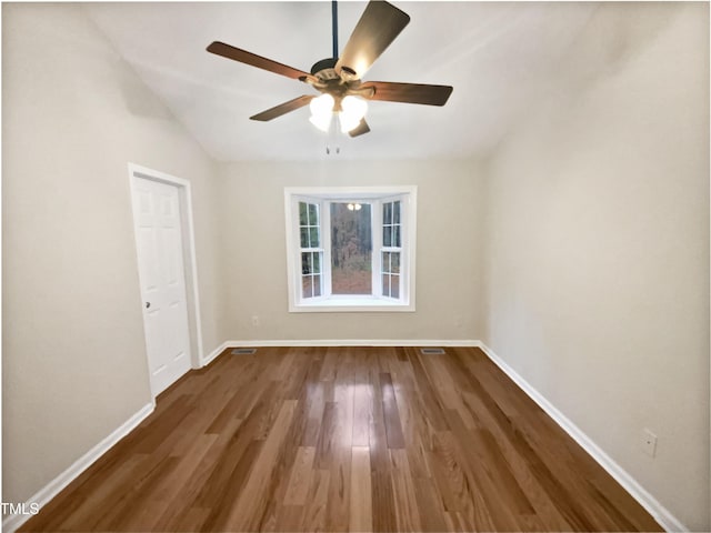 unfurnished room with wood finished floors, a ceiling fan, and baseboards