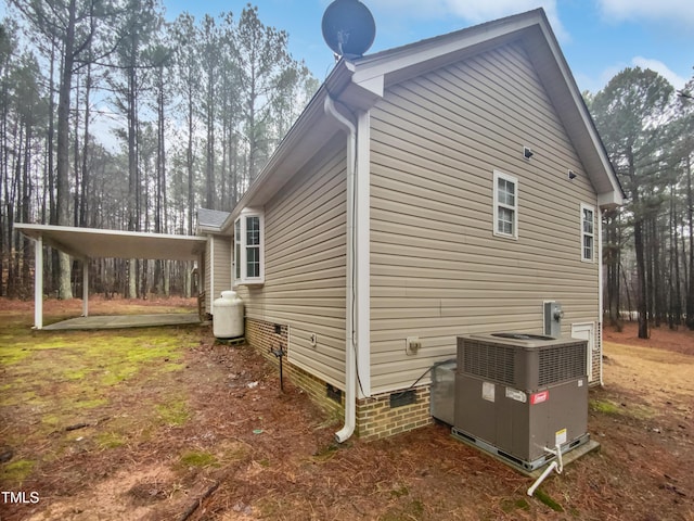 view of property exterior with crawl space and cooling unit