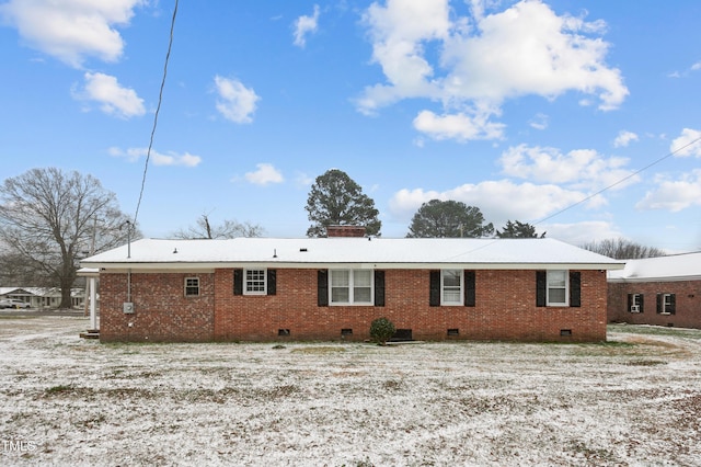 back of house featuring brick siding and crawl space