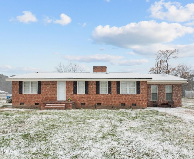 ranch-style home with crawl space, a chimney, a front lawn, and brick siding