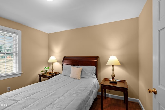 bedroom featuring wood finished floors and baseboards