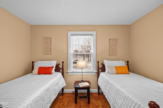 bedroom with baseboards and wood finished floors