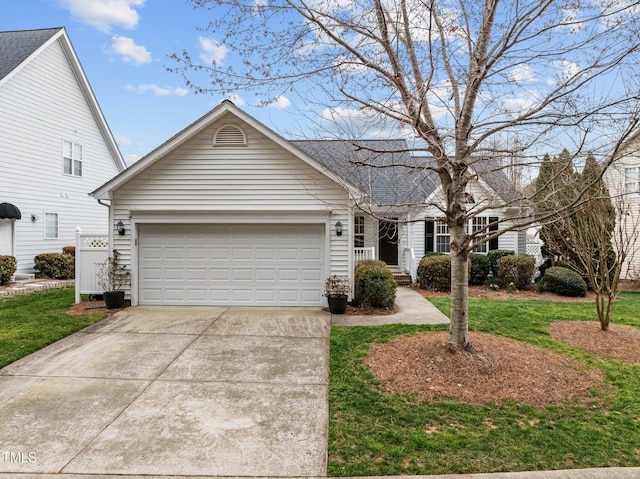 view of front of house featuring a garage, concrete driveway, a front lawn, and a shingled roof