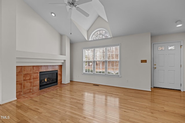 unfurnished living room featuring visible vents, baseboards, a fireplace, a ceiling fan, and wood-type flooring