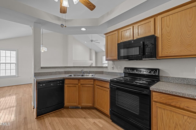 kitchen with a sink, black appliances, a ceiling fan, and light wood finished floors