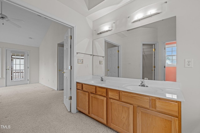 bathroom featuring double vanity, baseboards, a ceiling fan, and a sink