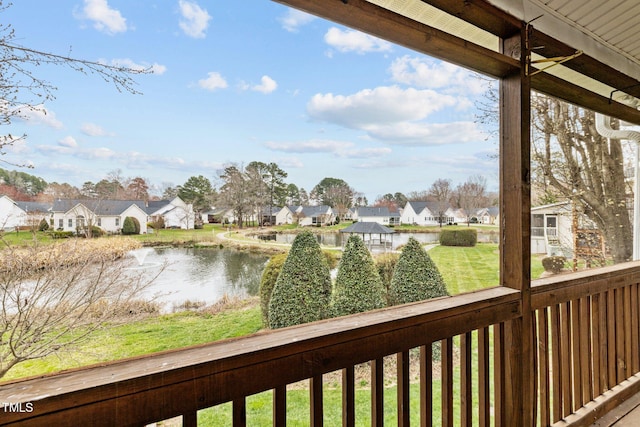 exterior space featuring a lawn, a residential view, and a water view