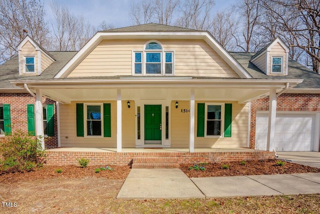 view of front of house featuring a porch, an attached garage, brick siding, a shingled roof, and concrete driveway