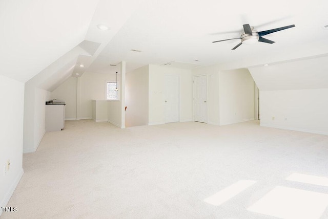 bonus room with lofted ceiling, light colored carpet, and ceiling fan