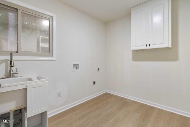 washroom featuring light wood-style flooring, washer hookup, baseboards, cabinet space, and electric dryer hookup