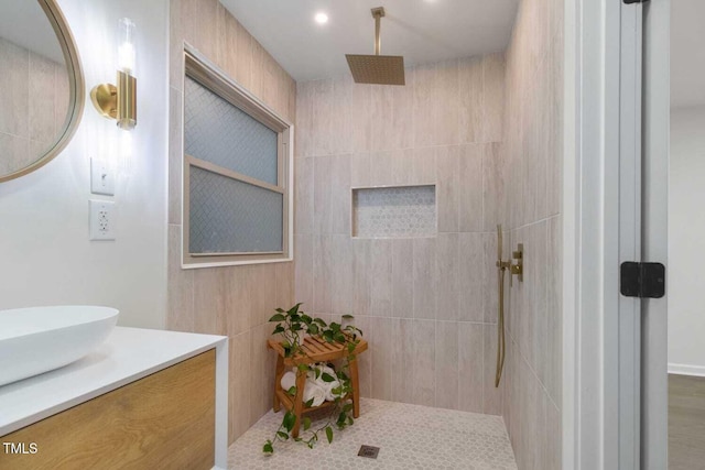 full bathroom with a walk in shower and vanity