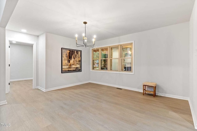 unfurnished room with a chandelier, light wood-type flooring, baseboards, and recessed lighting