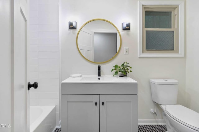 bathroom with baseboards, vanity, and toilet