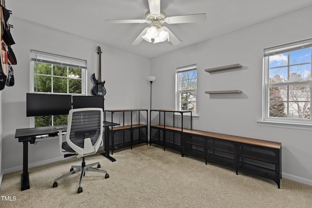 home office with carpet floors, baseboards, and a ceiling fan