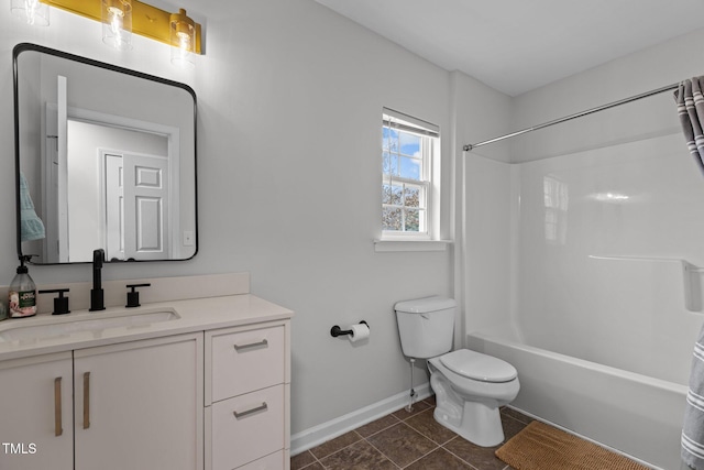 bathroom with baseboards, toilet, vanity, tile patterned flooring, and shower / bathtub combination