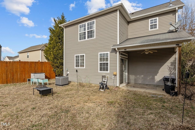 back of property featuring ceiling fan, central air condition unit, fence, a lawn, and a patio area