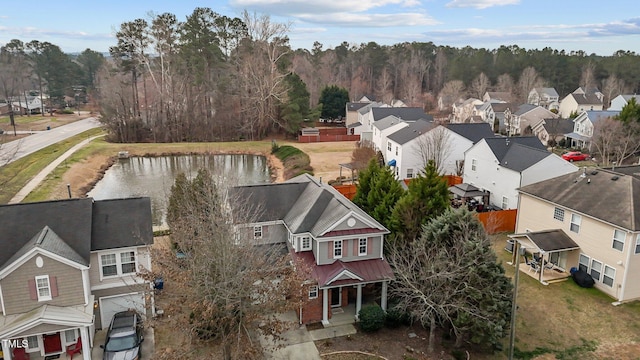 drone / aerial view with a water view and a residential view