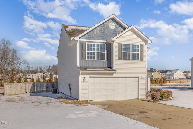 view of front of home featuring a garage, fence, driveway, a residential view, and board and batten siding