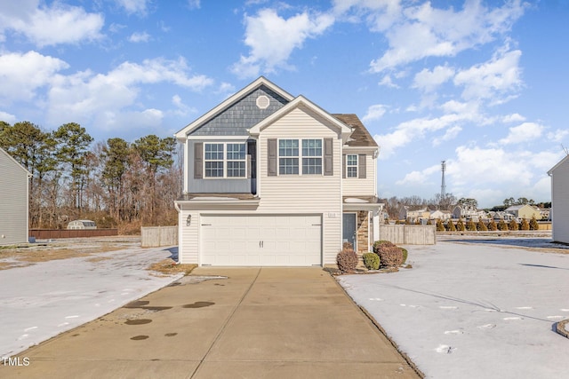 view of front of property with a garage, fence, and concrete driveway