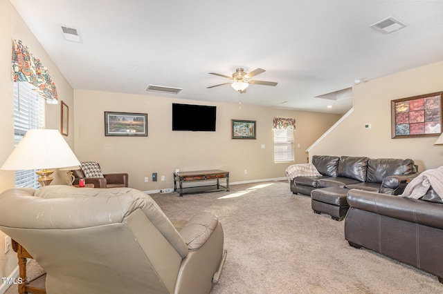 carpeted living area with a ceiling fan, visible vents, and baseboards