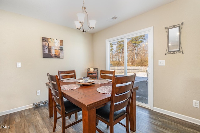 dining space featuring an inviting chandelier, baseboards, visible vents, and dark wood-style flooring