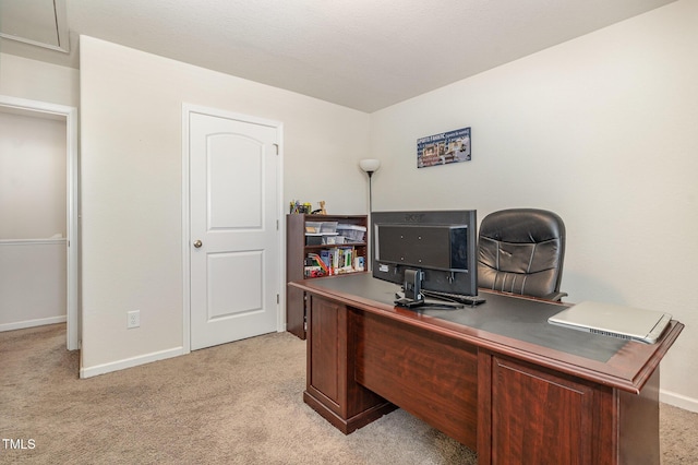 office with baseboards and light colored carpet