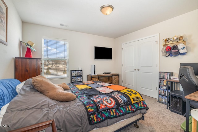 carpeted bedroom featuring a closet and visible vents