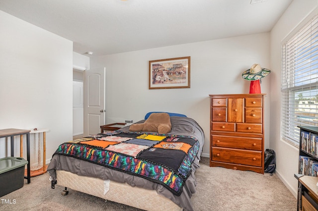 carpeted bedroom featuring baseboards