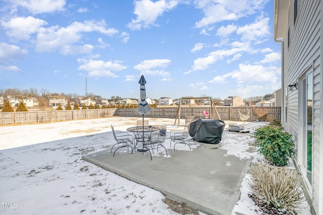 view of patio / terrace with outdoor dining area, a fenced backyard, and a grill