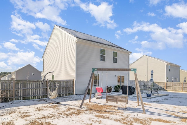 back of house with a fenced backyard and a patio