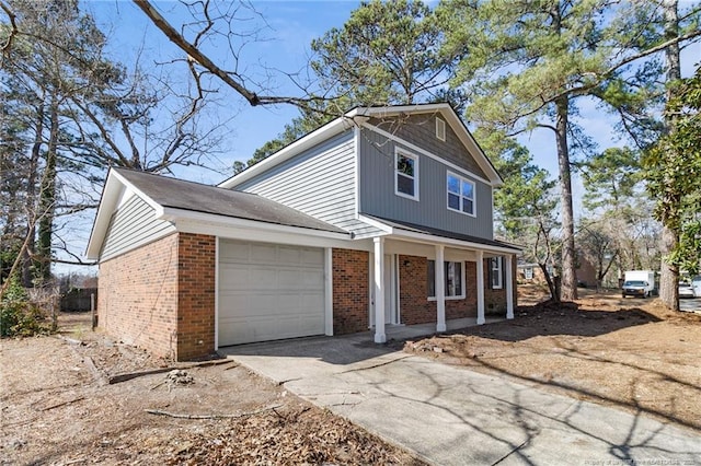 view of front of house featuring a garage, covered porch, concrete driveway, and brick siding