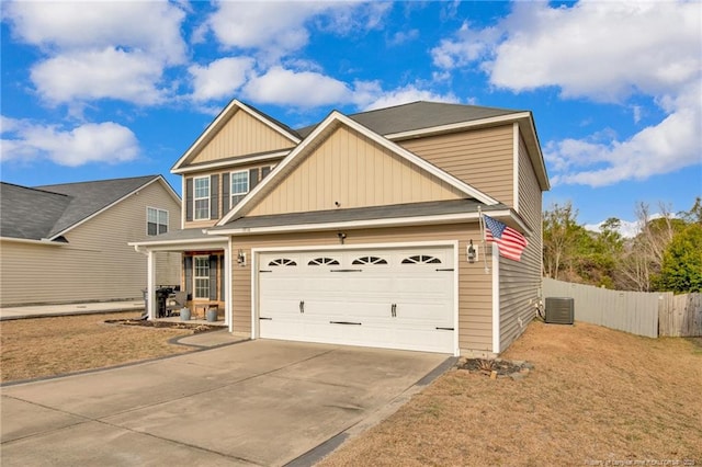 view of front of home with driveway, an attached garage, fence, and central air condition unit