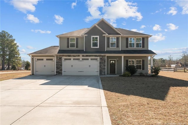 craftsman-style house with stone siding, concrete driveway, a porch, and an attached garage