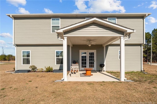 back of house with a patio area, a lawn, a ceiling fan, and french doors